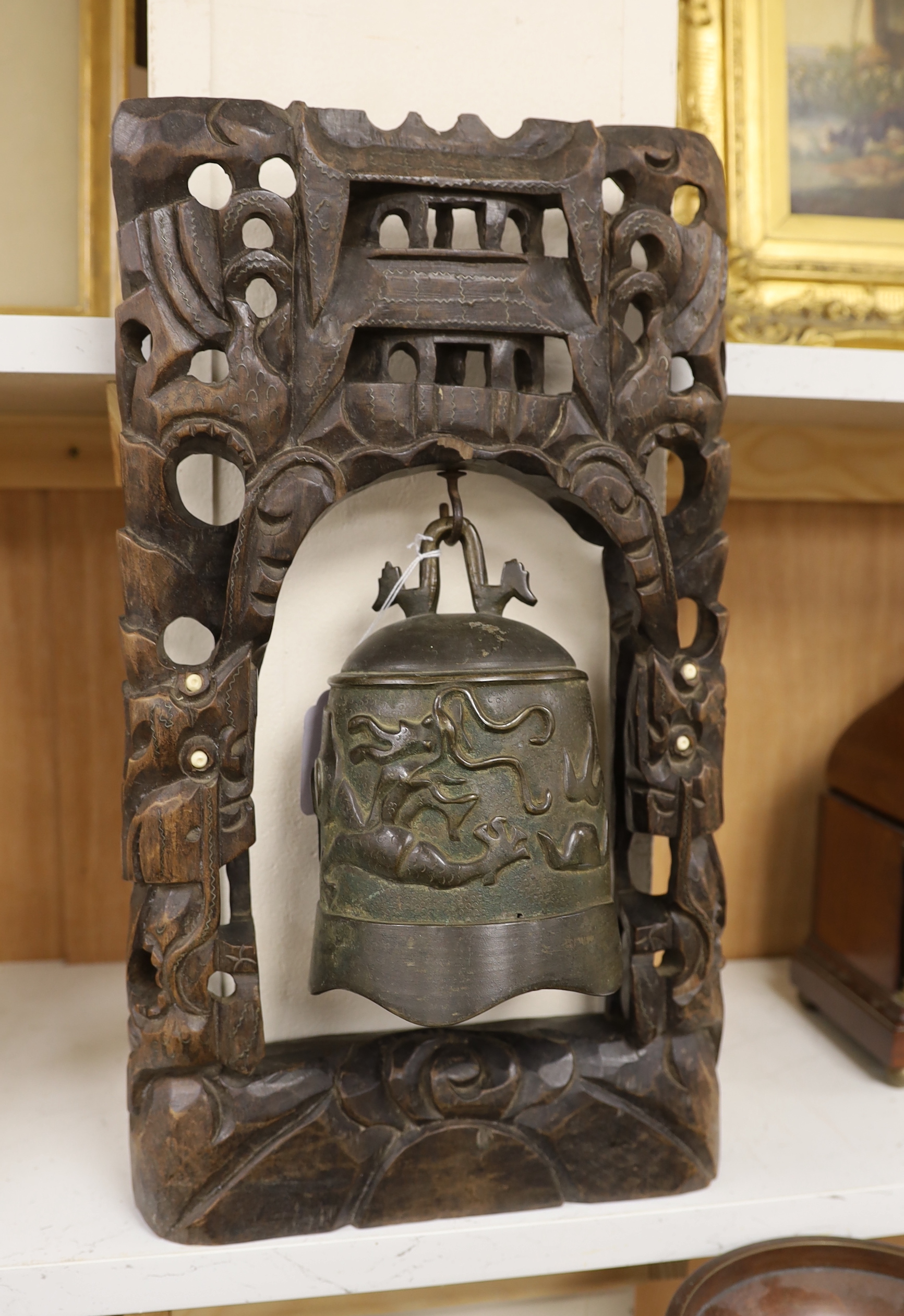 A Chinese bronze gong on carved hardwood stand, 44cm high